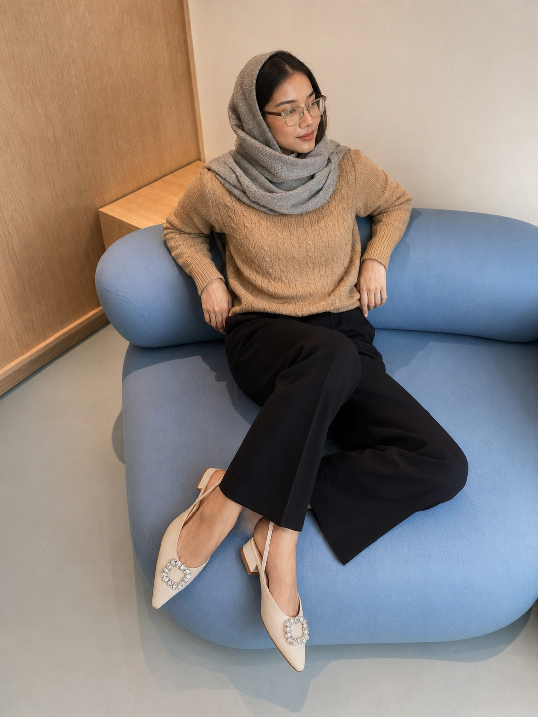 Woman styling Buvia shoes in a relaxed interior